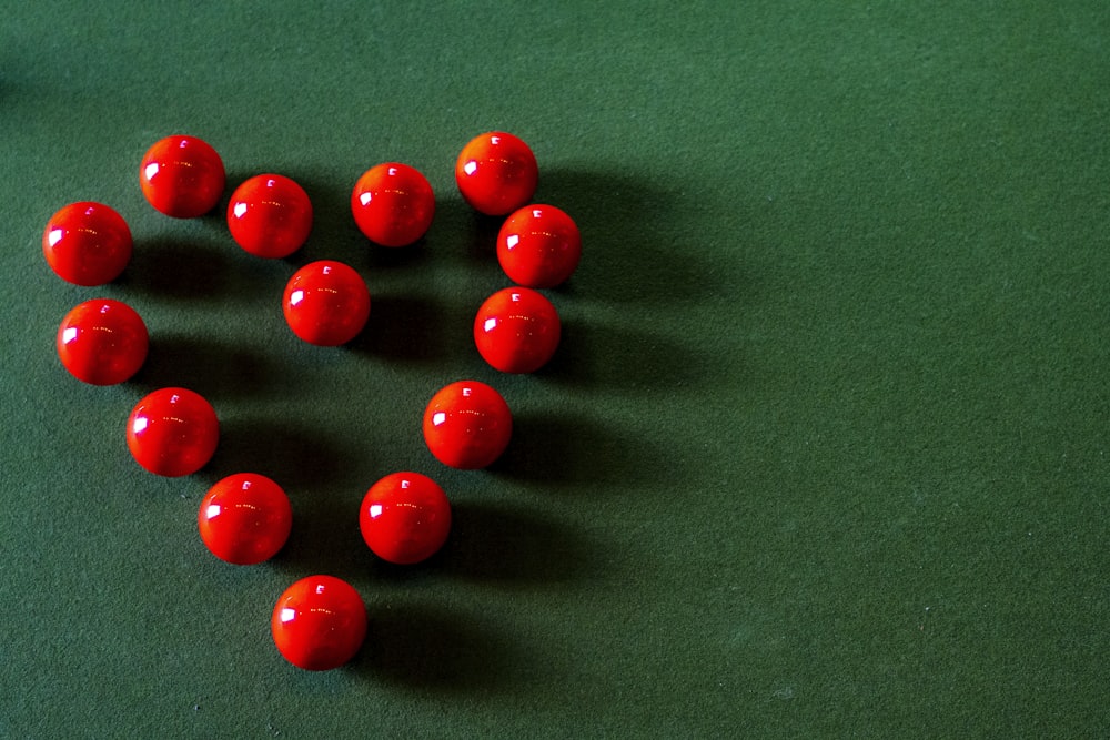 red round beads on green textile