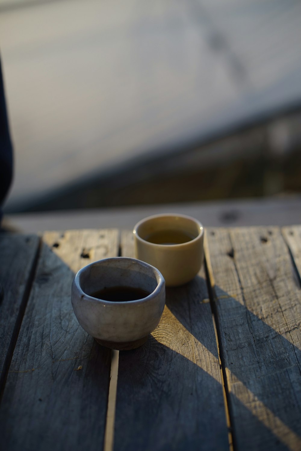 white ceramic cup on brown wooden table