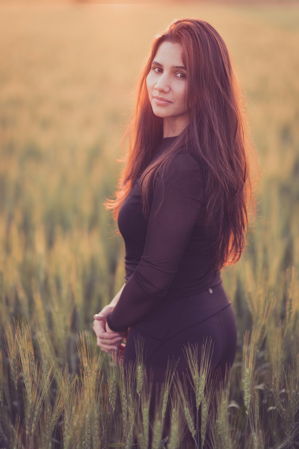 woman in black long sleeve shirt standing on green grass field during daytime