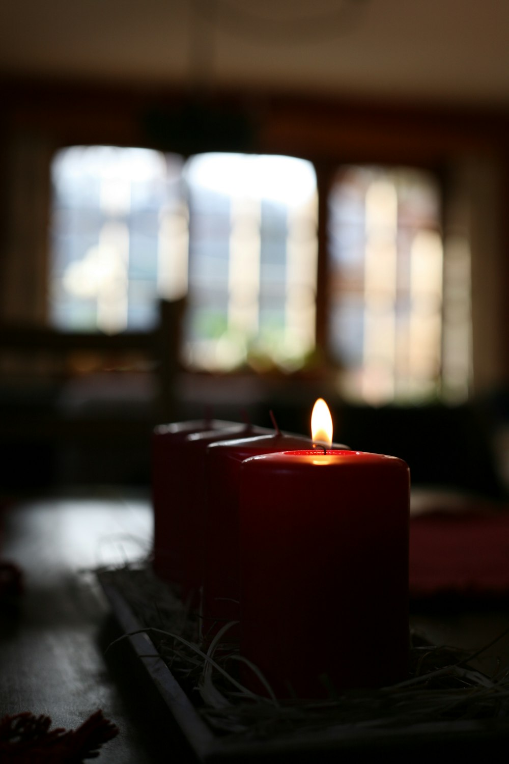 red pillar candle on table
