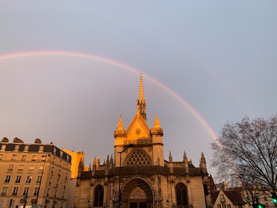 brown concrete building under rainbow in Šv. Lauryno bažnyčia France