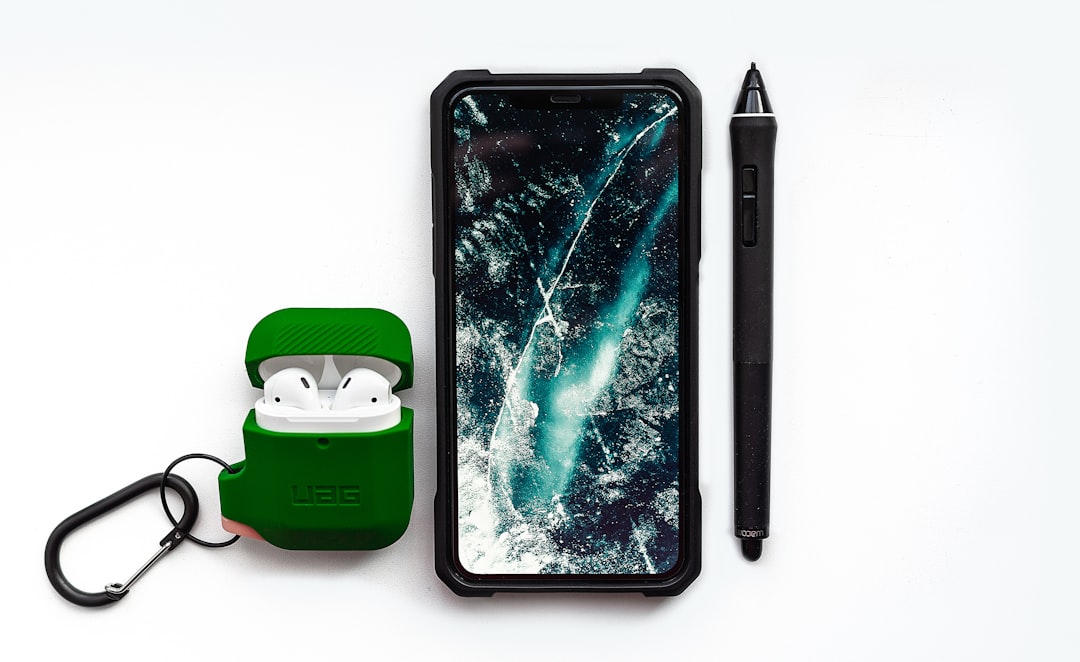 black smartphone beside black pen