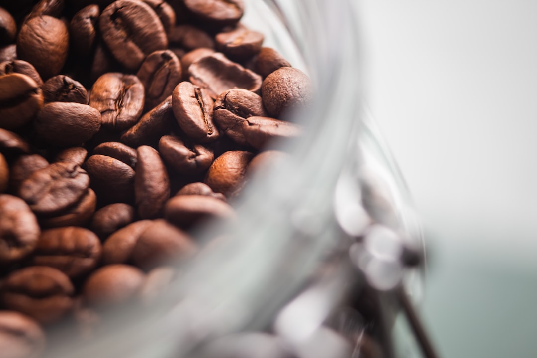 brown coffee beans in clear glass container