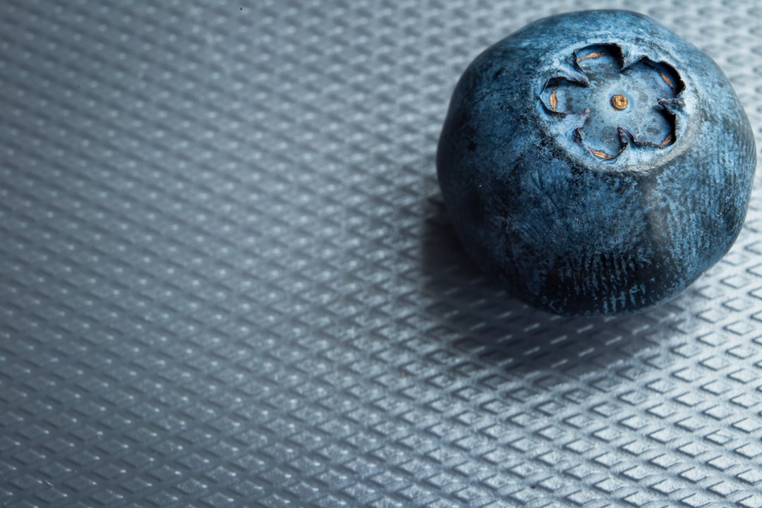 brown round fruit on white textile