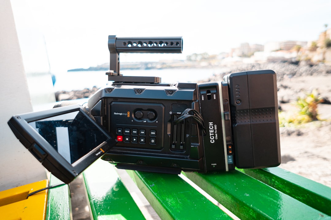 black canon dslr camera on green and white wooden table