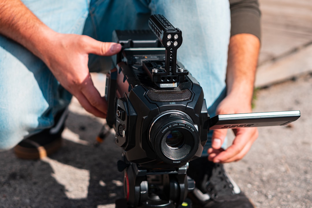 person holding black dslr camera