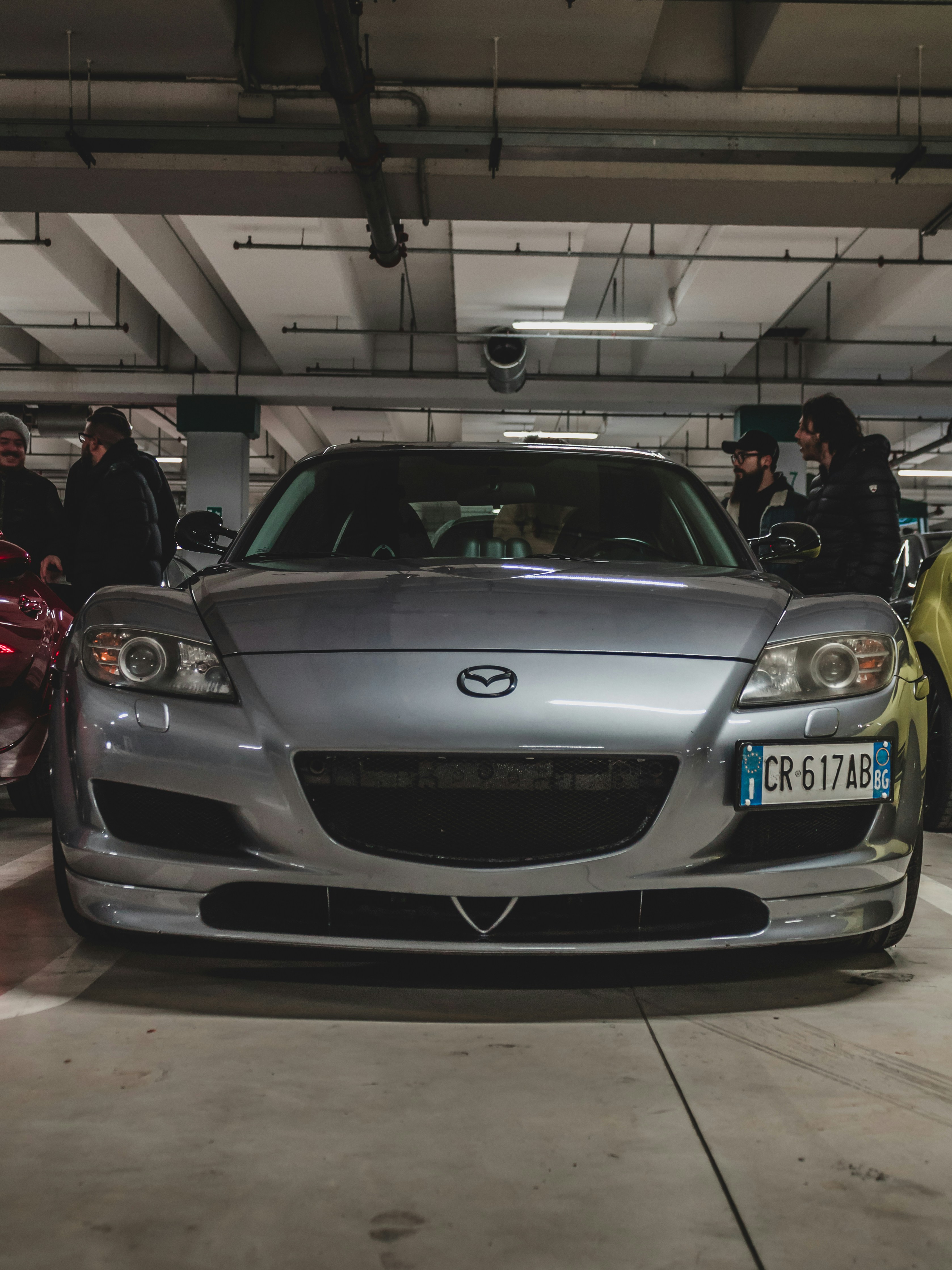 silver imported sports car parked indoors