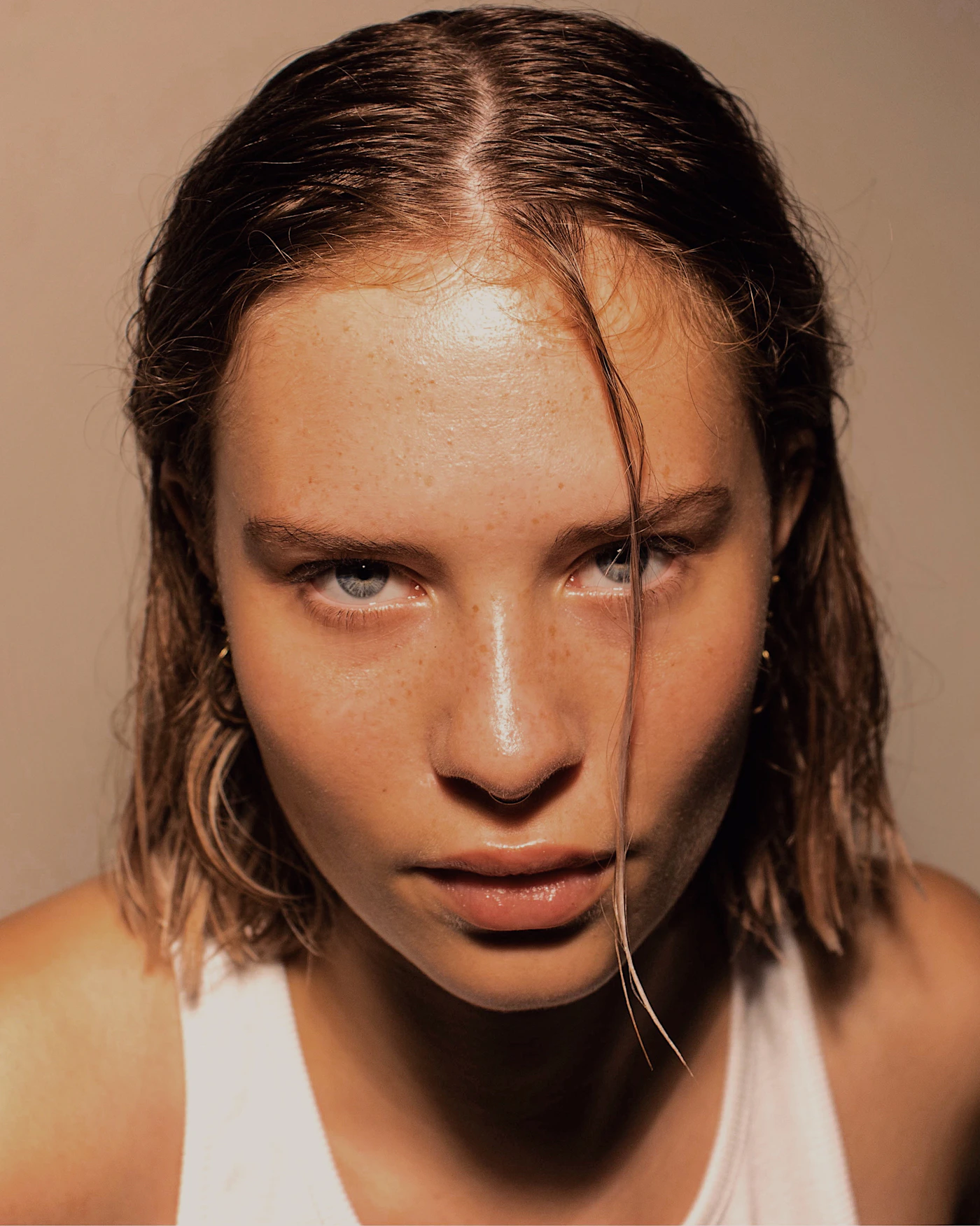 Close-up beauty portrait of a woman with clear, healthy, glowing skin under soft natural light, representing the overall skin-quality goals of a combined skin booster plan