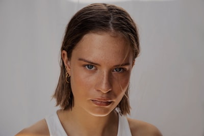 woman in white tank top fierce zoom background