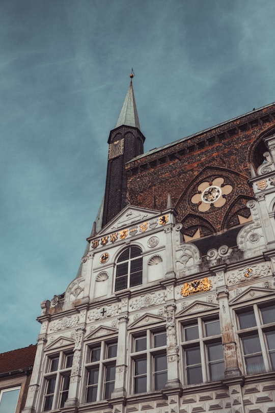 brown and white concrete building under white clouds during daytime in Town Hall Germany