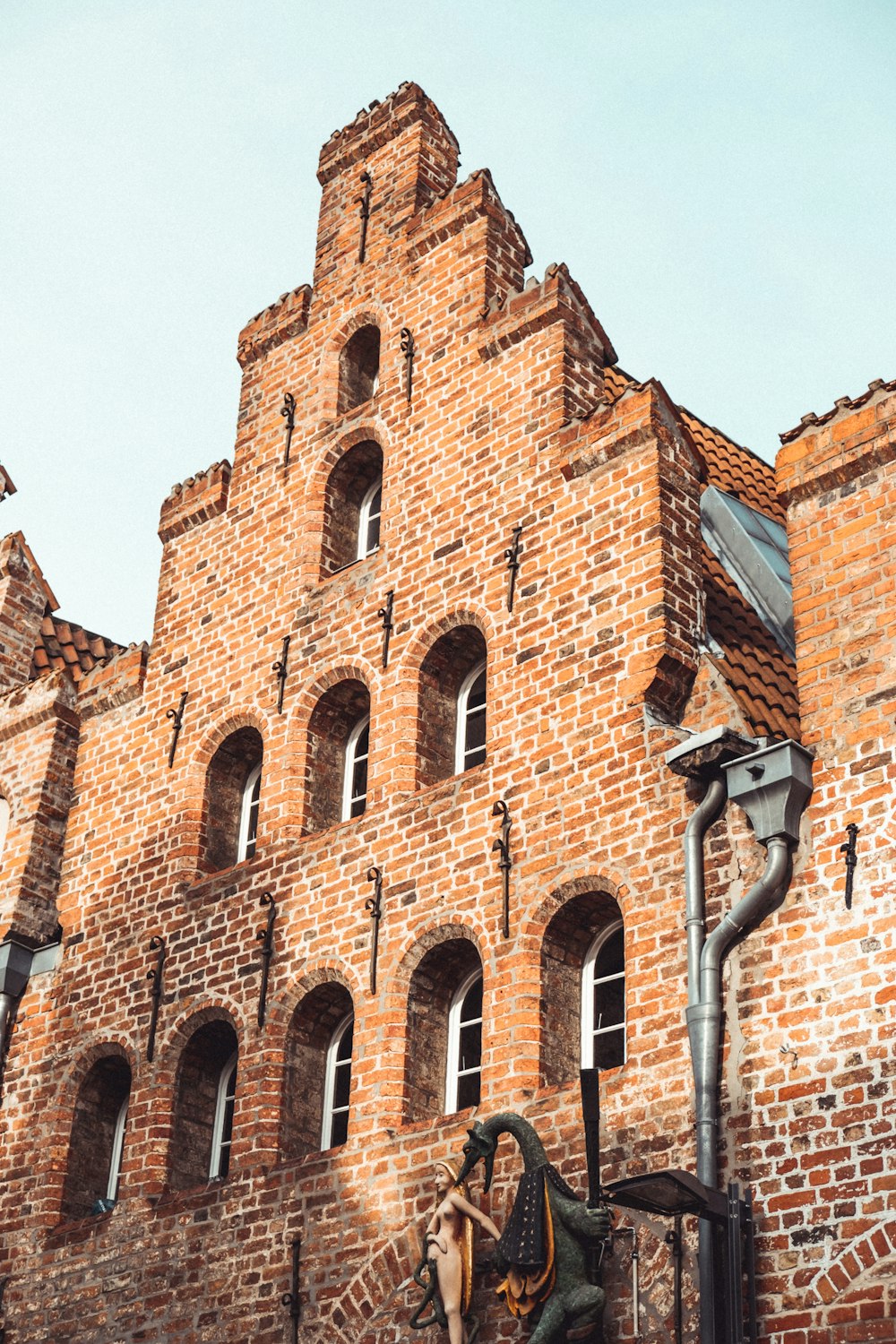 brown brick building under blue sky during daytime