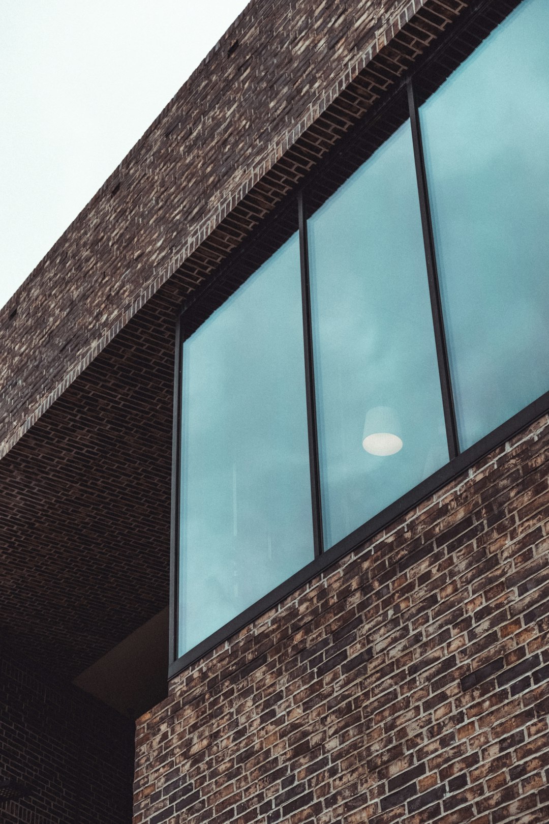 brown brick building with glass window