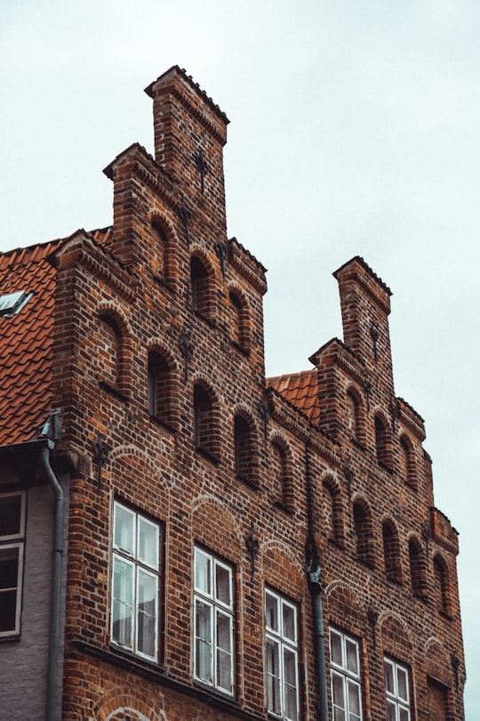 brown concrete building during daytime in Lübeck Germany