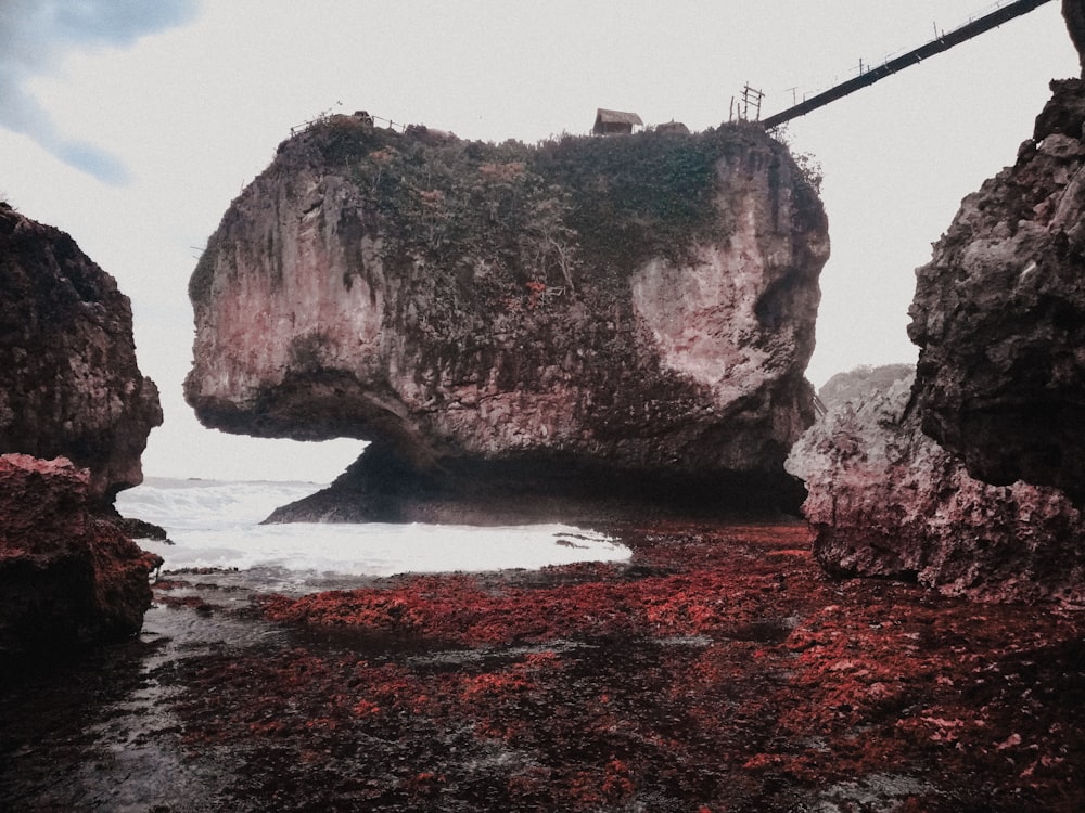 brown rock formation on body of water during daytime