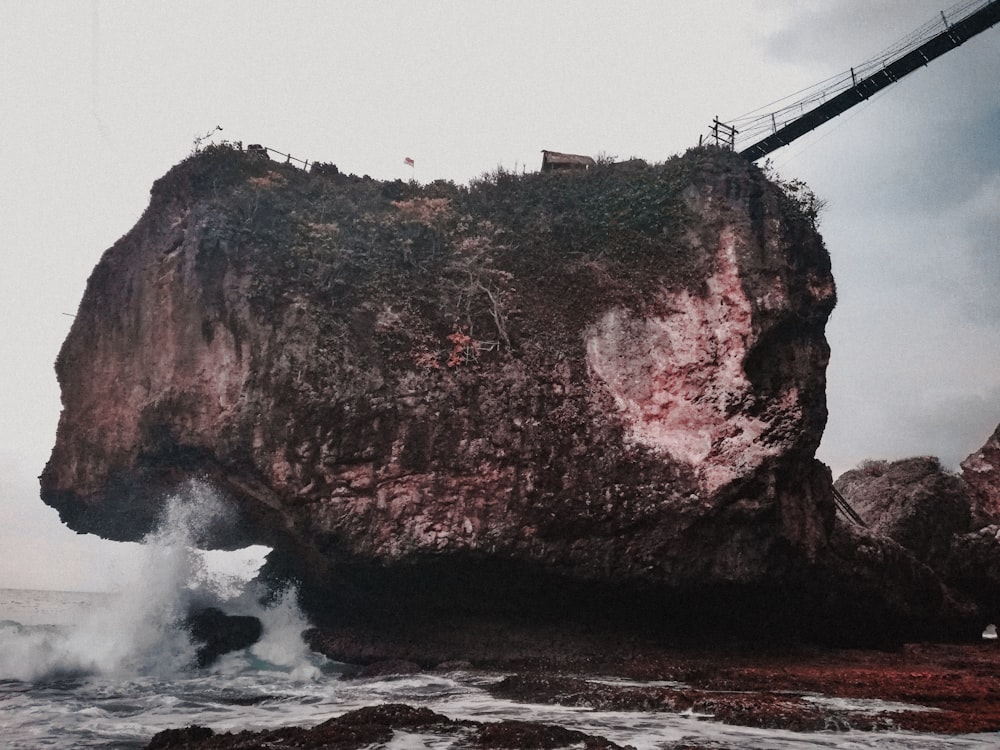 brown rock formation near body of water during daytime