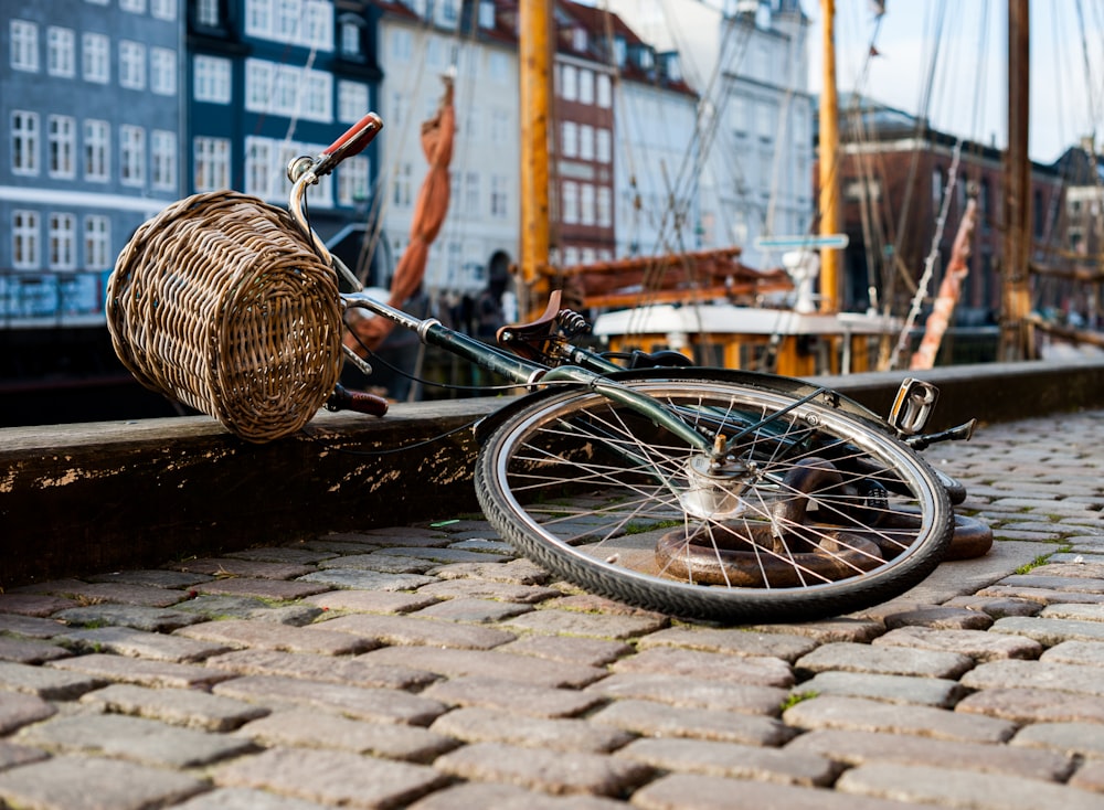 brown woven basket on black bicycle