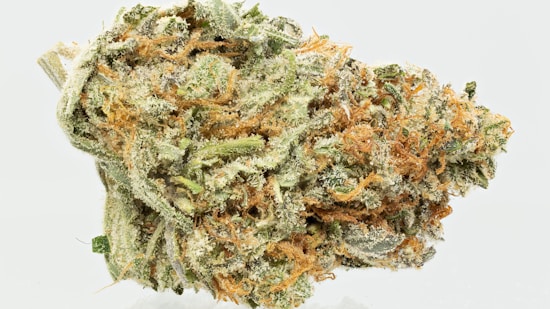 A detailed close-up of a cannabis bud showcasing its intricate texture. The bud is covered in a generous coating of white crystalline trichomes, interspersed with orange pistils and shades of green leaves.