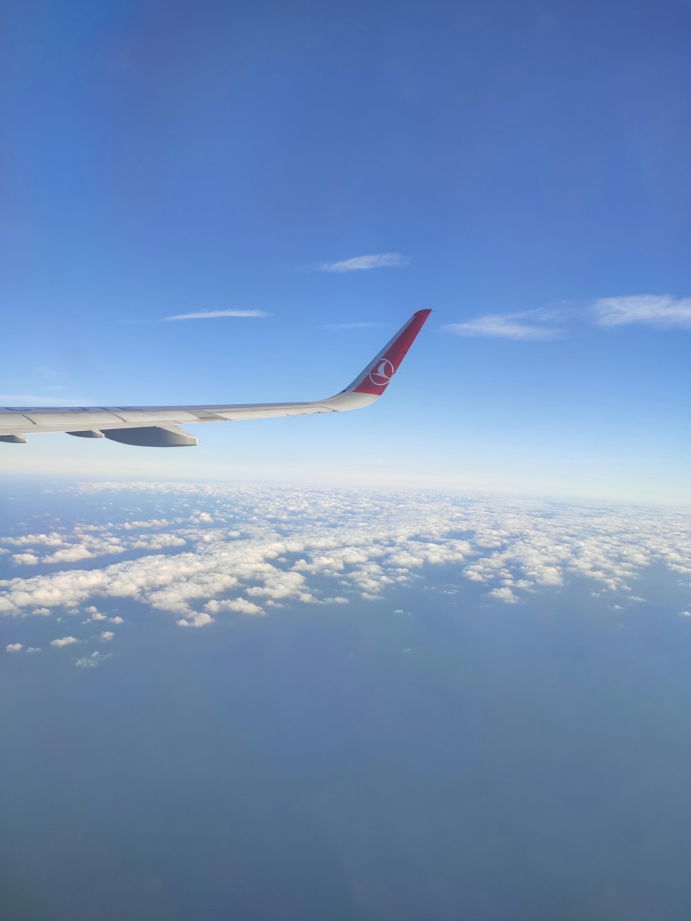 red and white airplane wing during daytime