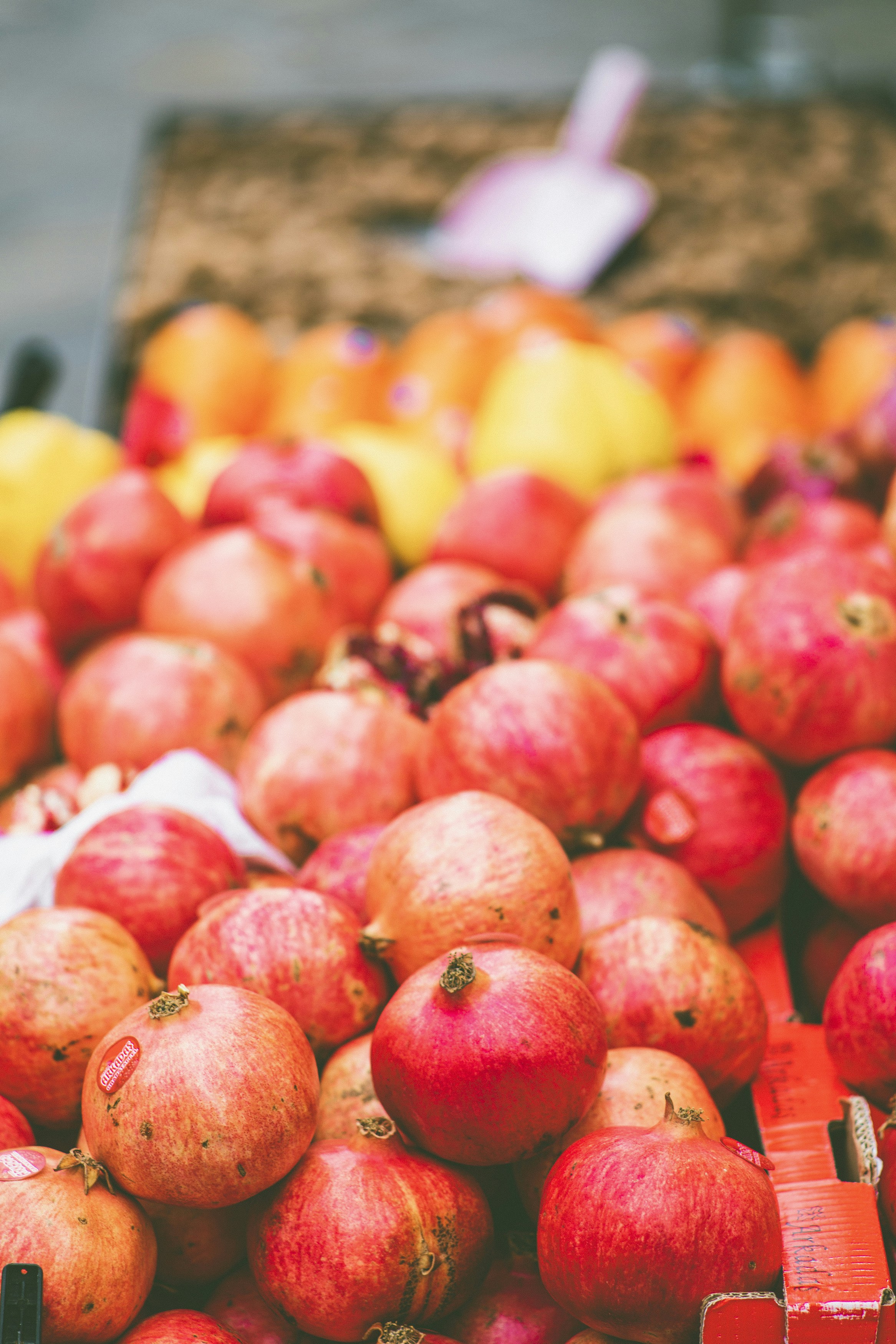 Fresh bio pomegranate at farmers market. Made with Canon 5d Mark III and analog vintage lens, Leica Elmarit-R 2.8 135mm (Year: 1987)