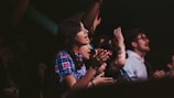 Audience enjoying a lively dance event with enthusiastic applause.