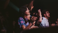 Audience clapping and cheering during an energetic live music event.