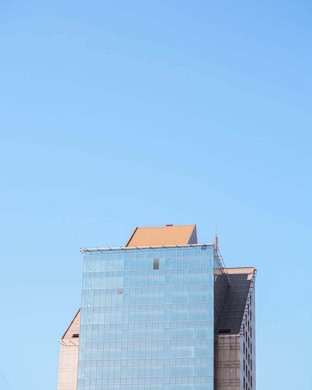 blue and brown concrete building under blue sky during daytime