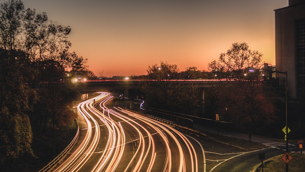 time lapse photography of cars on road during sunset