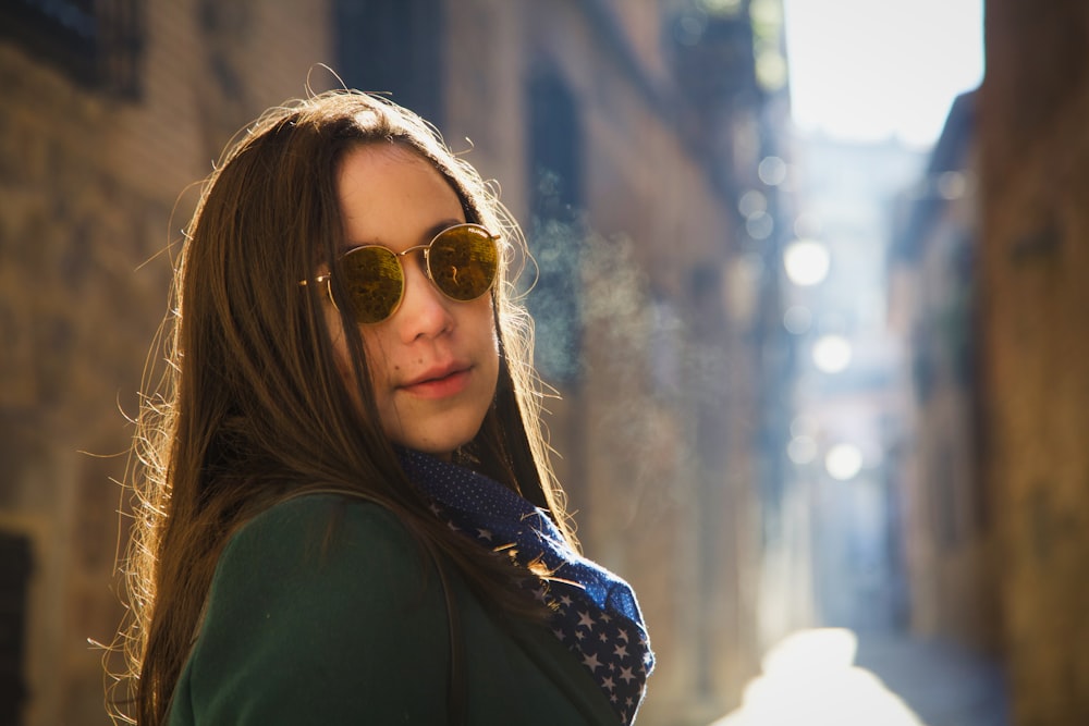 woman in black jacket wearing brown sunglasses