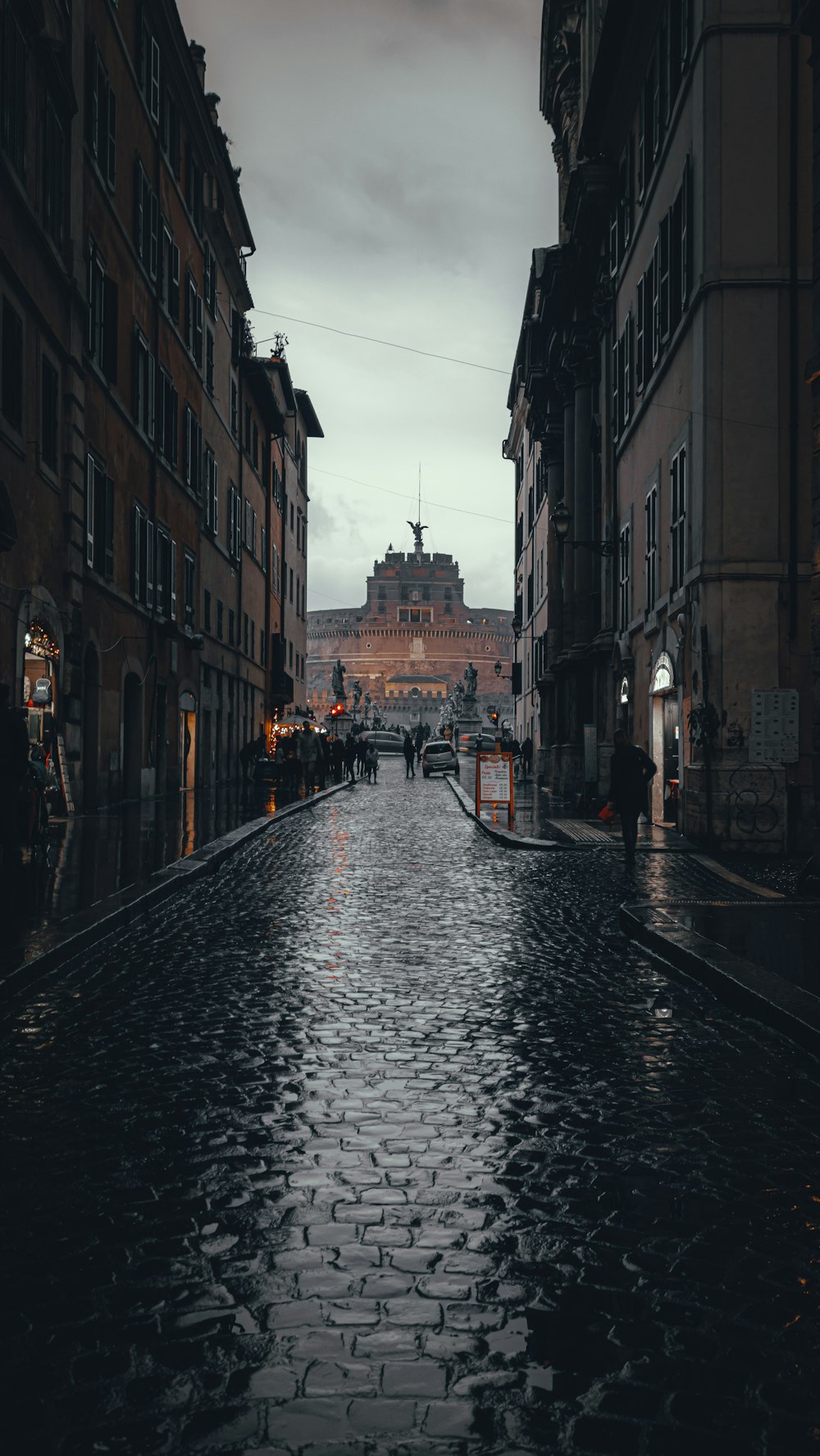 people walking on street between buildings during daytime