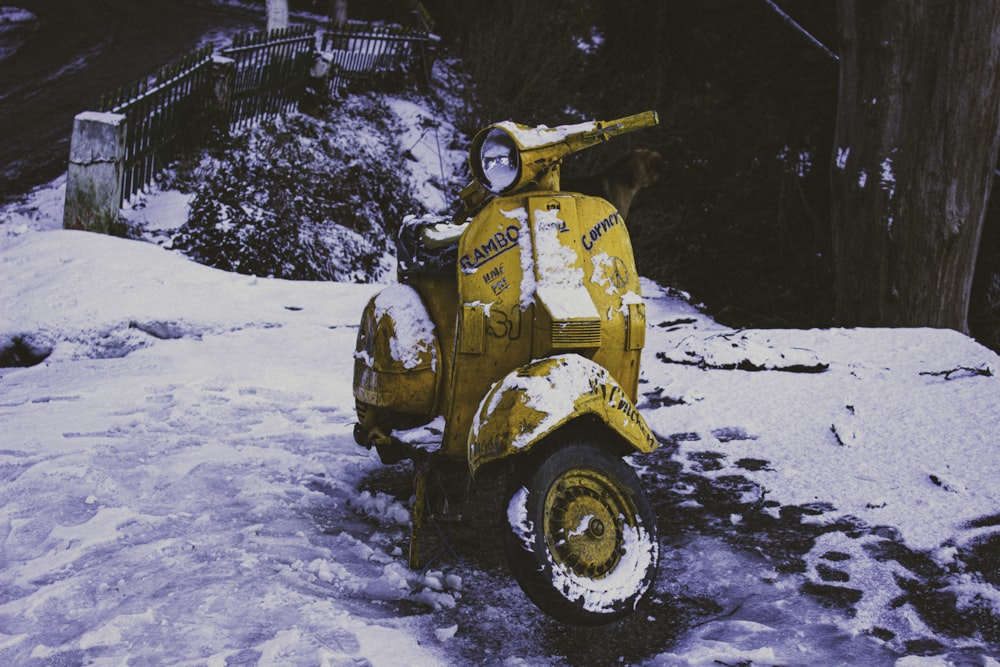 yellow and black atv on snow covered ground