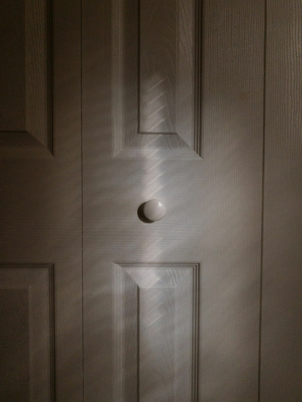 white wooden door with silver door knob