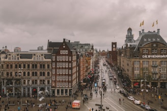 people walking on street near buildings during daytime in Amsterdam Dam Square