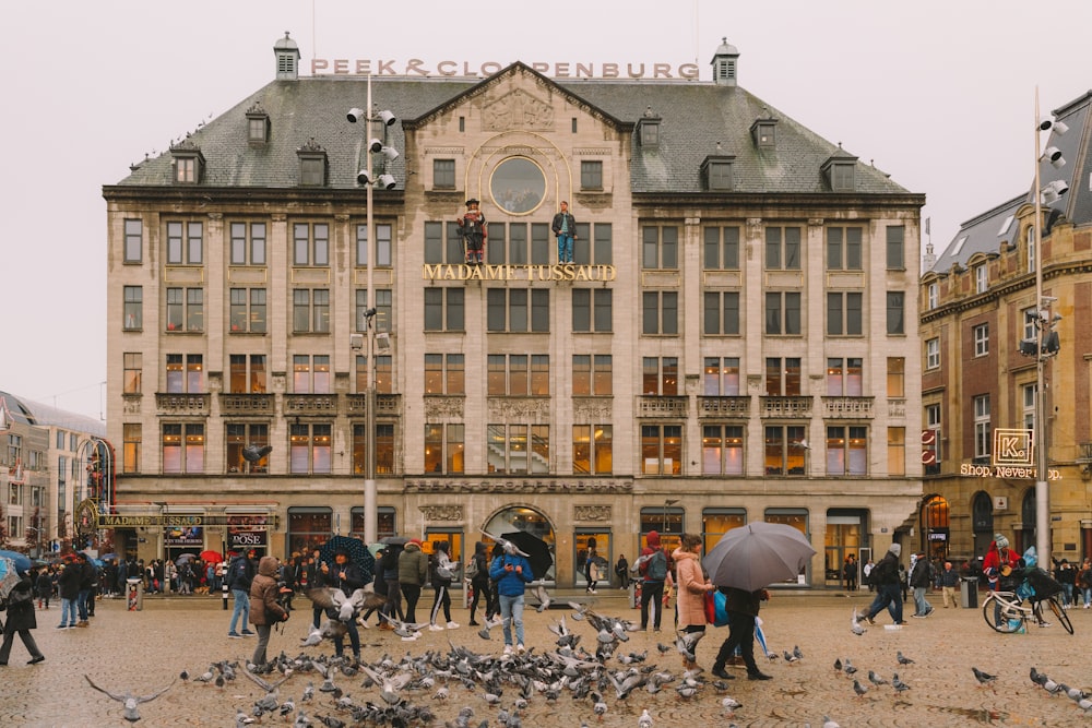 people walking around brown concrete building during daytime