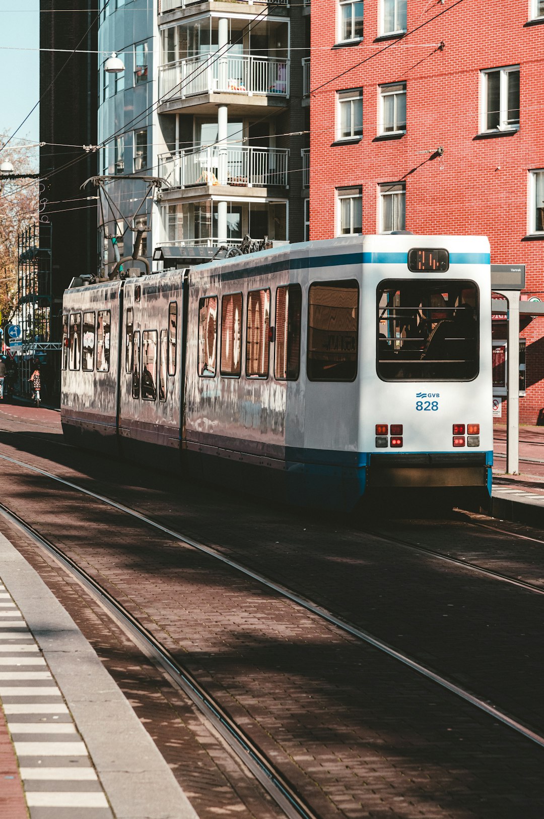 white and blue train on rail road during daytime