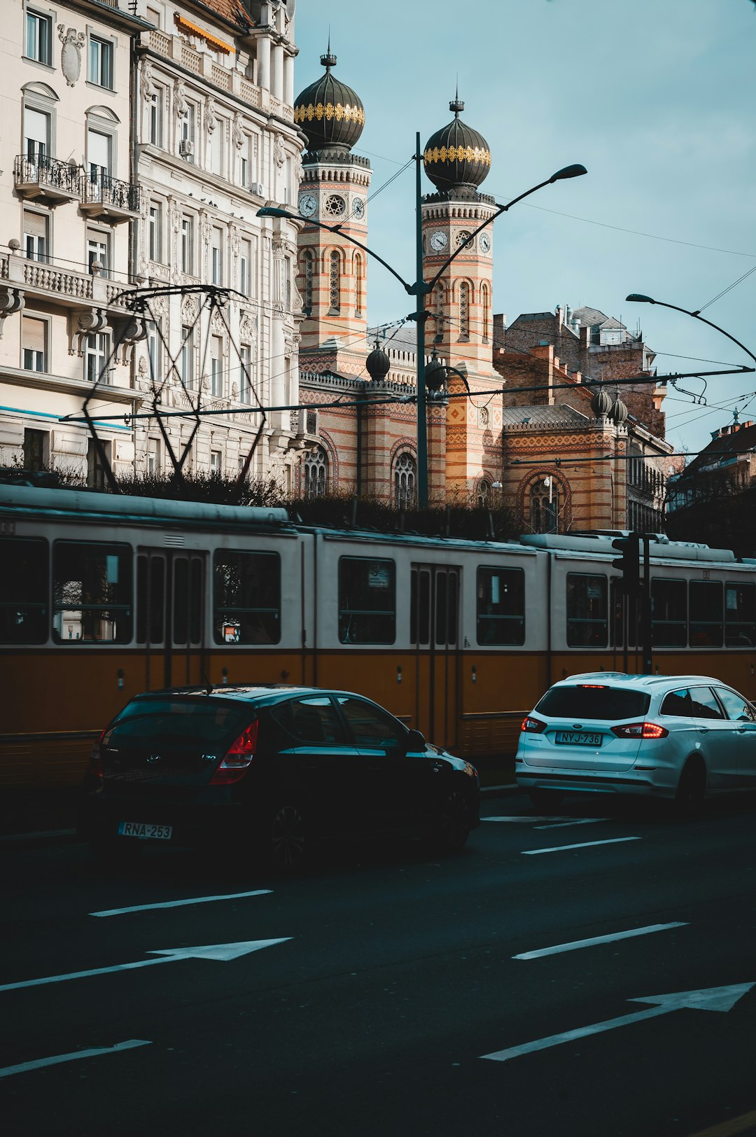 cars parked in front of brown building