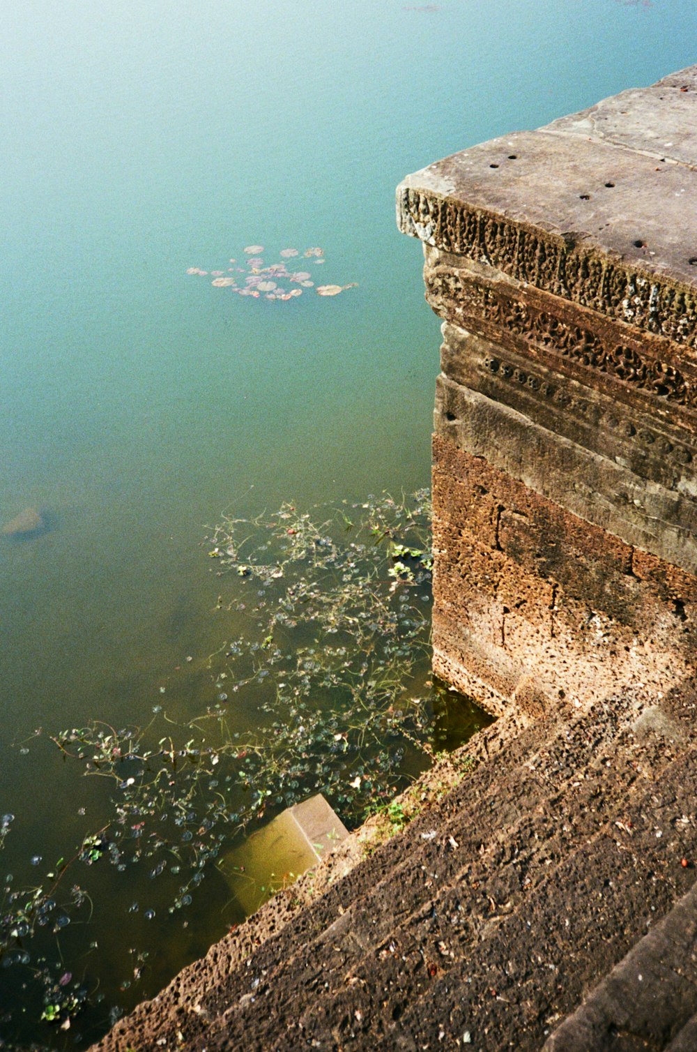 brown concrete building near body of water during daytime