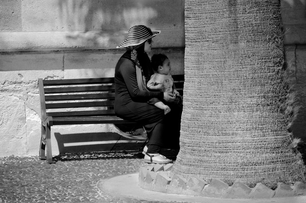 man and woman kissing on bench