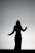 silhouette of woman raising her hands