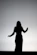 silhouette of woman raising her hands