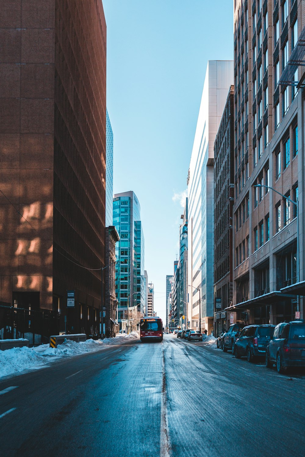 cars on road near high rise buildings during daytime