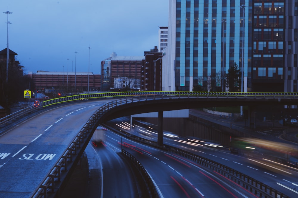 cars on road near city buildings during daytime