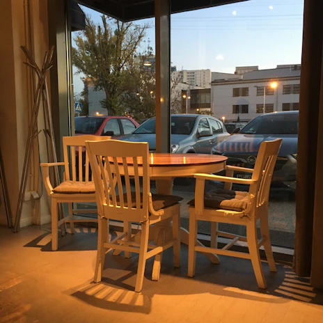 A cozy corner inside Lezzet Durağı with wooden tables and customers enjoying their meals.