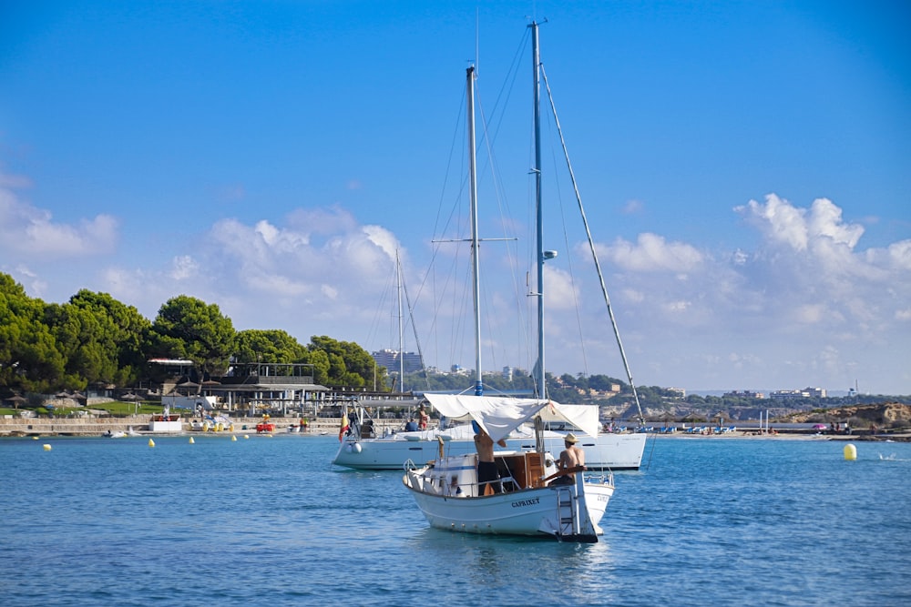 white boat on sea during daytime