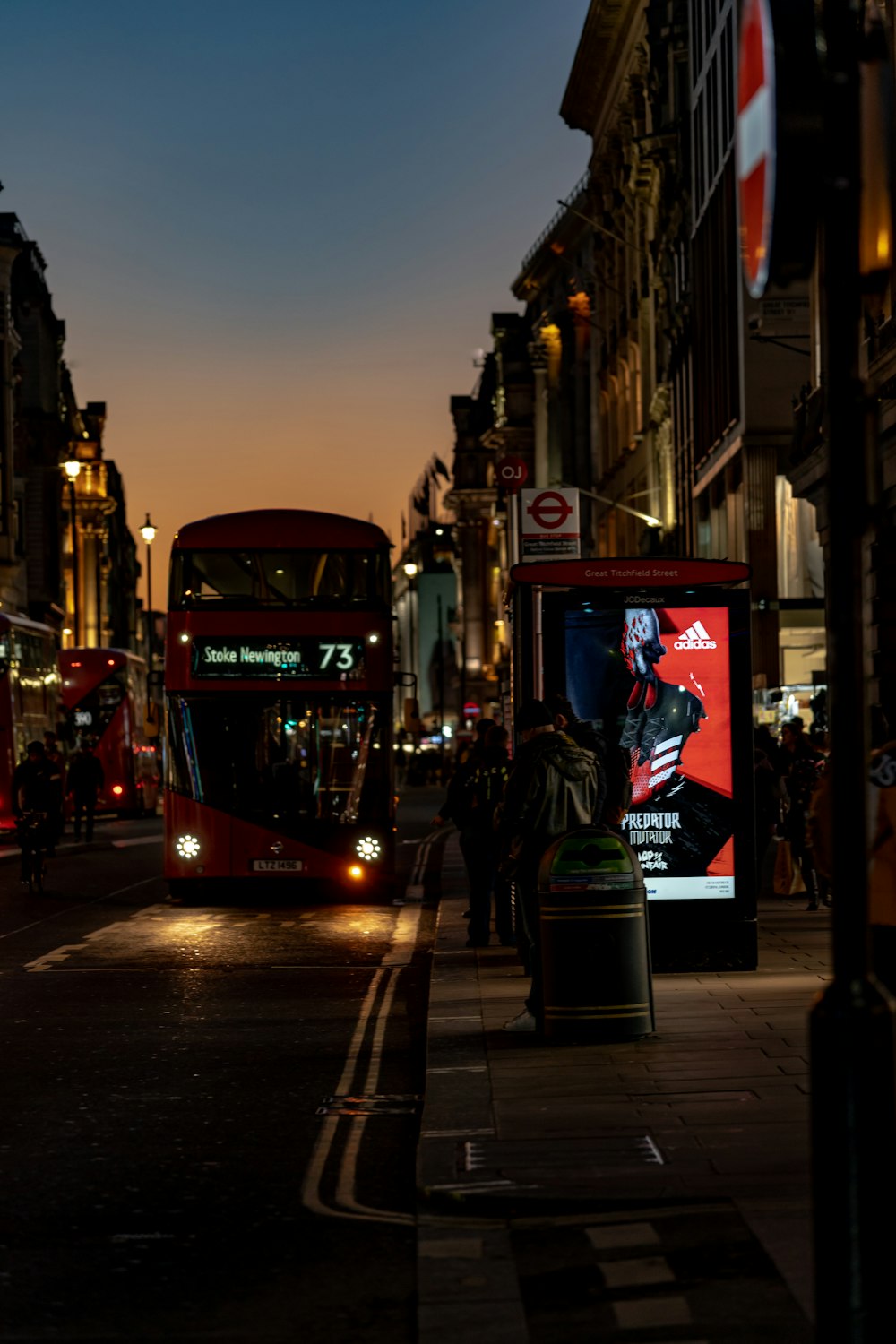 red and black tram on the street during night time