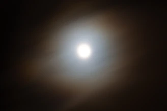 Two soft glowing halos intertwined, warm color palette symbolizing harmony and connection.
