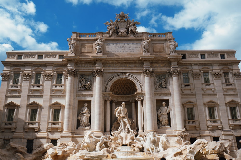 white concrete building with statues