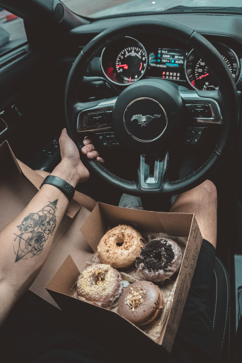 person in brown pants sitting on driver seat