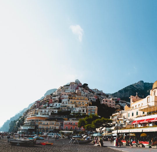 people walking on street near buildings during daytime in Lattari Mountains Regional Park Italy