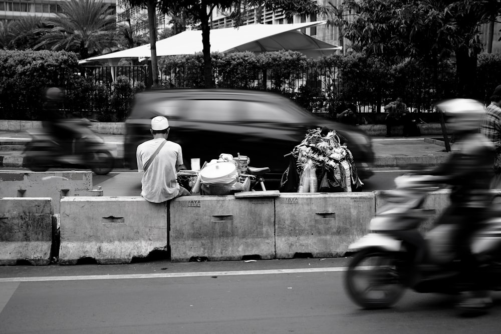 grayscale photo of man and woman riding motorcycle