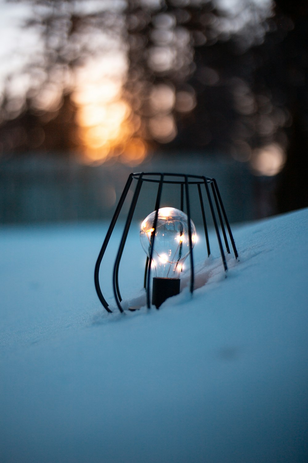 clear glass ball on snow covered ground during daytime